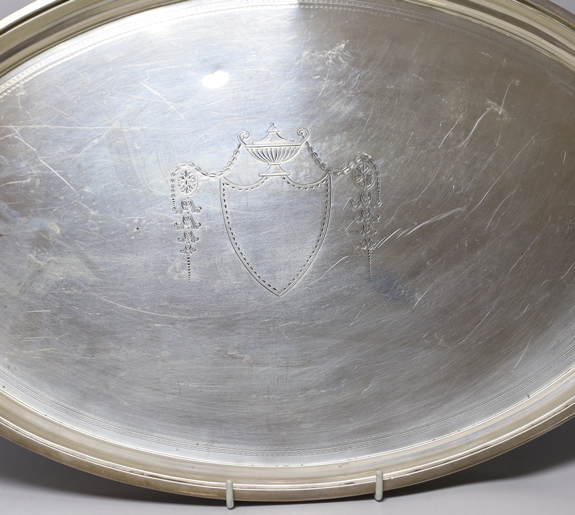 A George V silver elliptical two handled tea tray, Edward Barnard & Sons, London, 1911, 62.6cm over handles